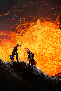 men in mouth of volcano